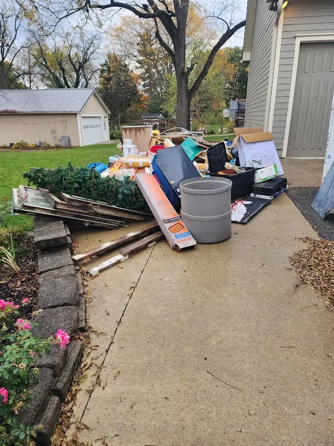 Dumpster being loaded with debris for Estate Cleanout Dumpster Rental in Harlan